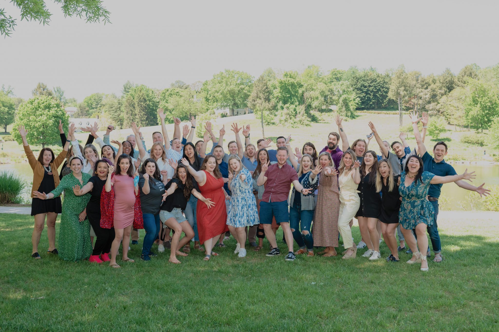 Group shot of GiveCampus team celebrating outdoors at retreat in Charlottesville.
