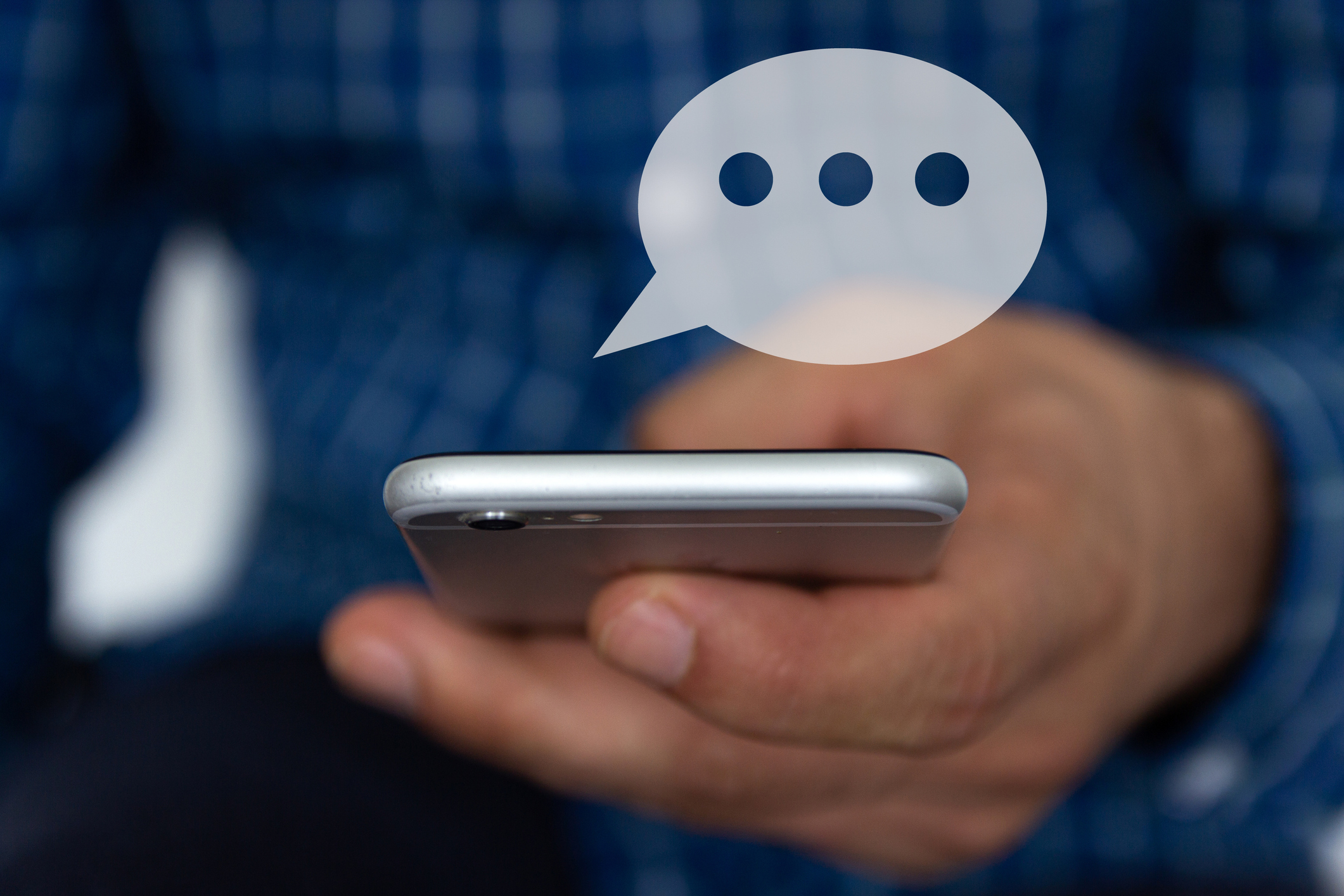 Hand of man typing text on mobile smartphone.